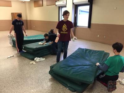 Cleaning sleeping mats that the homeless use in the shelter
